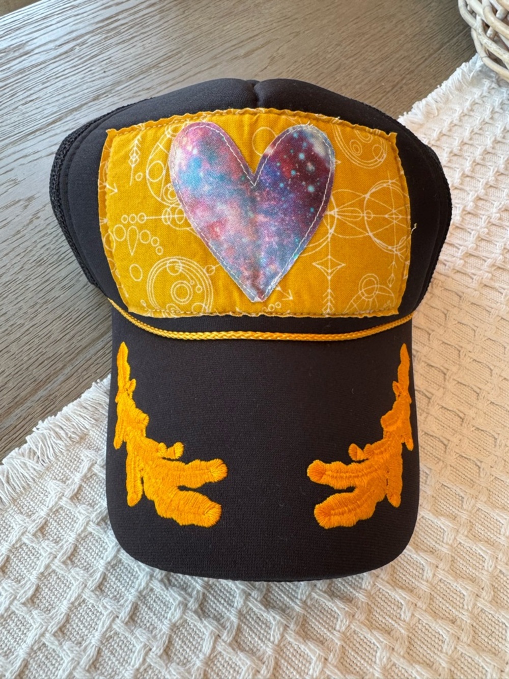 HEC Studio Black Trucker Hat with Yellow Patch & Galaxy Heart